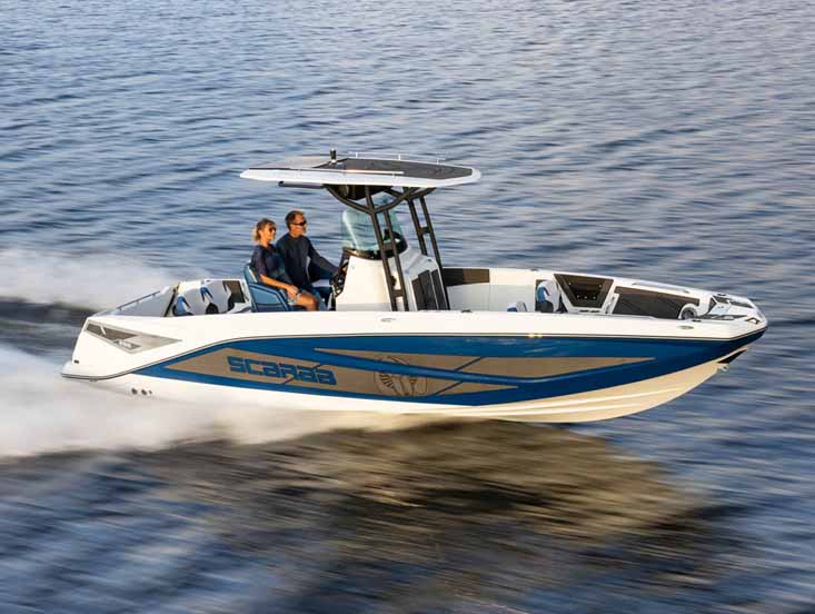 Couple riding on a Scarab model boat on the ocean