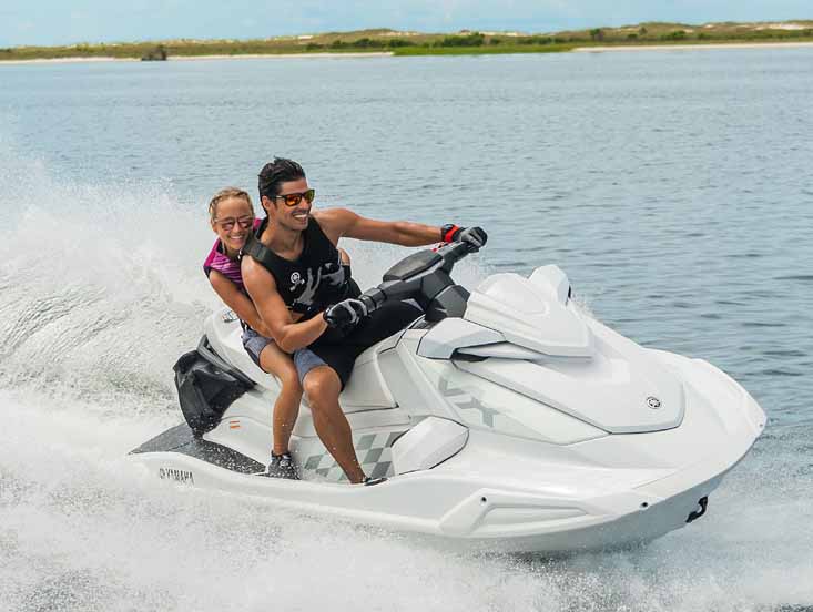 Yamaha waverunner with a couple on it having fun and smiling