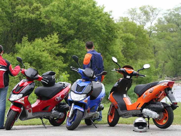 Guys at park with there KYMCO Scooters