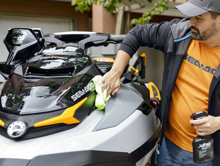 Person with Sea-Doo branded clothing washing his PWC