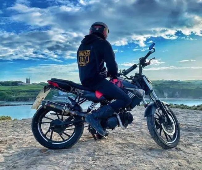 Kymco dirt bike overlooking a body of water