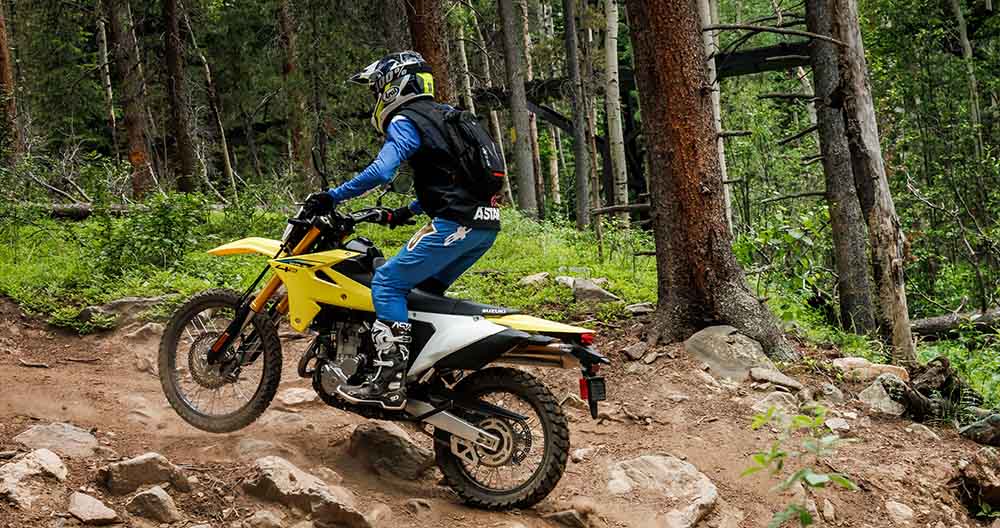 Dirt bike climbing dirt trail hillside