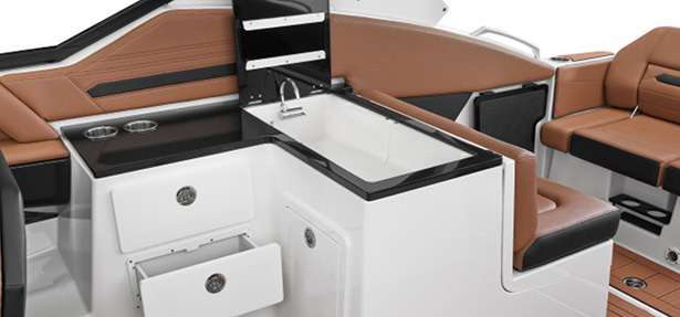Modern onboard galley station on the Yamaha 295 Series with stainless steel sink, black countertops, and storage drawers.