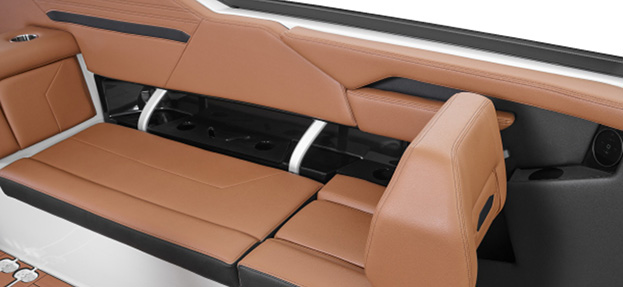 Versatile brown and black rear bench seating in Yamaha 295 series boat with under-seat storage access and premium stitching