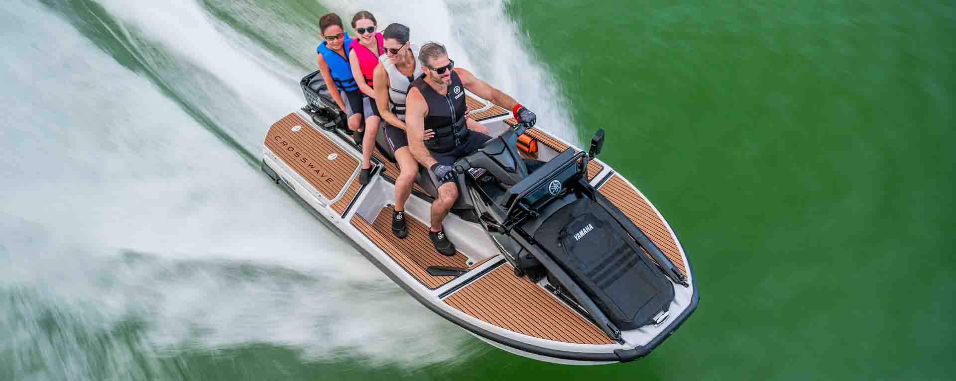 Yamaha CrossWave watercraft speeding across open water with a family onboard
