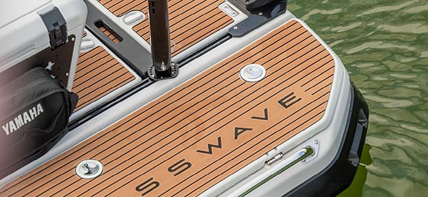 Detailed view of the CrossWave branded faux teak decking on the stern, illustrating premium materials and custom styling.