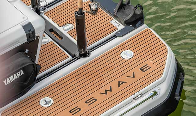Wide stern deck Wide stern deck of Yamaha CrossWave with CrossWave logo, fishing rod holders, and marine accessories visible for action-ready use.