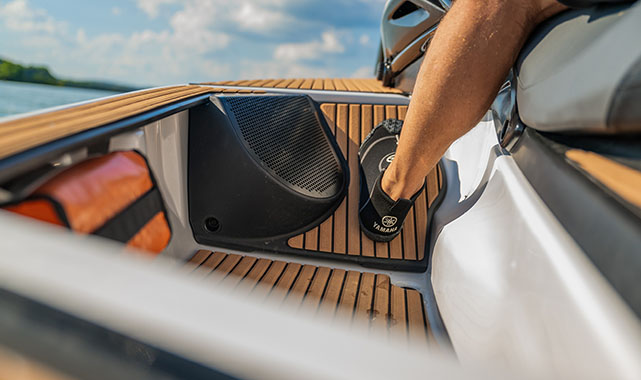 Yamaha Crosswave footwell Close-up view of a Yamaha Crosswave footwell area with an integrated marine speaker and storage compartment in view.