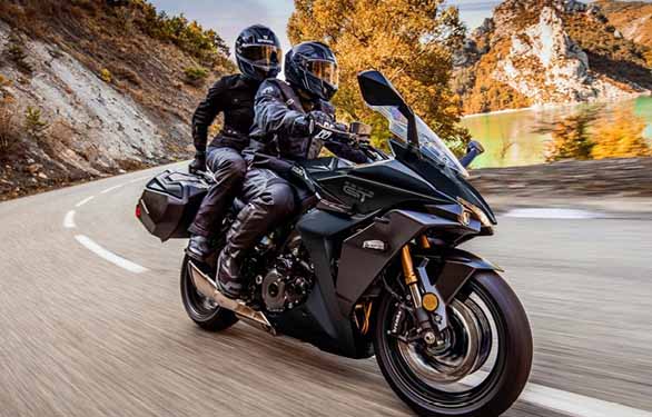 Suzuki Bike with couple on it riding downhill